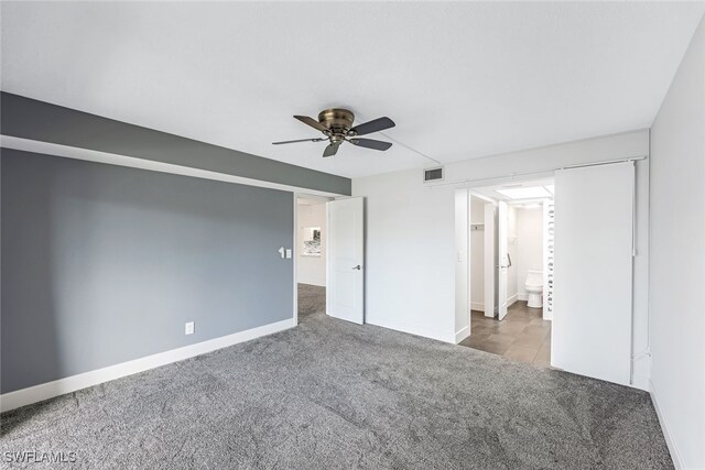 unfurnished bedroom with visible vents, baseboards, carpet, and a ceiling fan