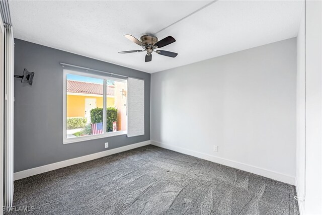 unfurnished room with baseboards, carpet floors, and a ceiling fan