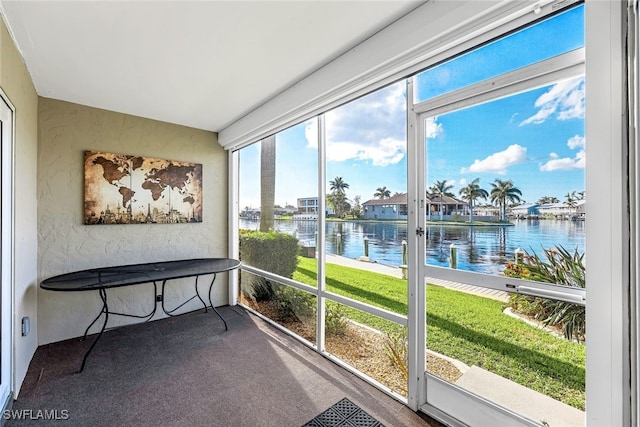 sunroom / solarium featuring a water view