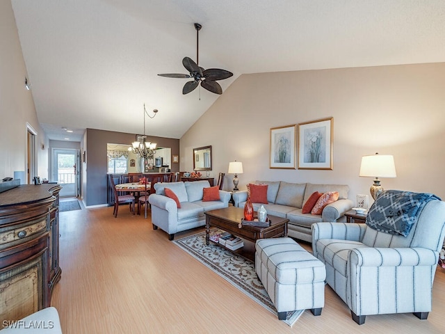 living room featuring light hardwood / wood-style flooring, ceiling fan with notable chandelier, and lofted ceiling