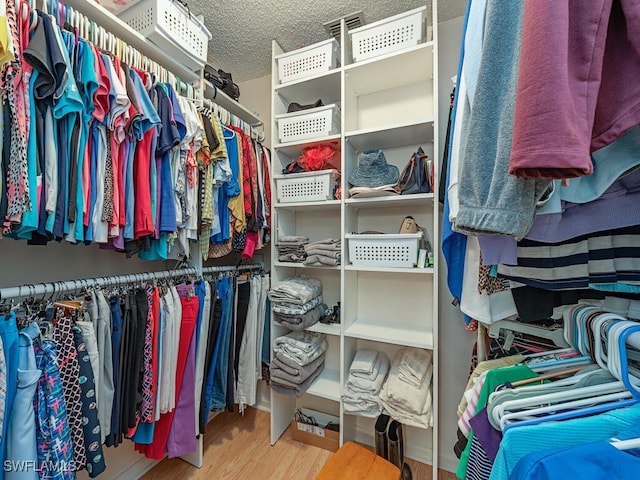 spacious closet featuring hardwood / wood-style flooring