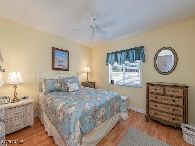 bedroom featuring ceiling fan and light hardwood / wood-style floors