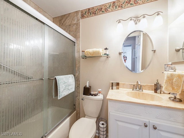 full bathroom with shower / bath combination with glass door, vanity, and toilet