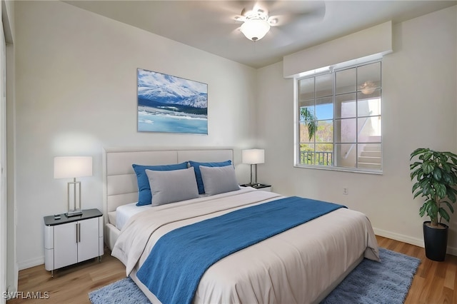 bedroom with ceiling fan and wood-type flooring