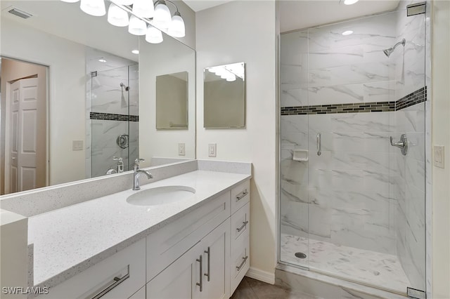 bathroom featuring vanity and a shower with door