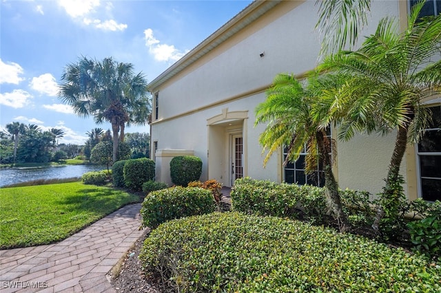 exterior space with a water view and a yard