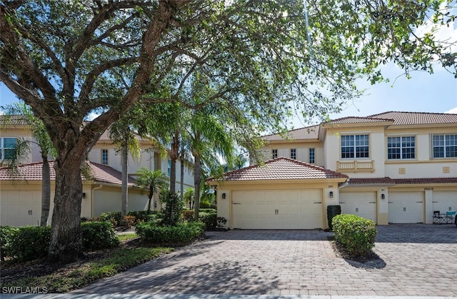 26414 Lucky Stone Rd Unit 101, Bonita Springs, FL 34135 - view of front facade featuring stucco siding, a tile roof, and decorative driveway