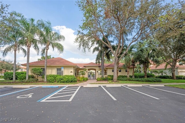 26414 Lucky Stone Rd Unit 101, Bonita Springs, FL 34135 - view of building exterior featuring uncovered parking
