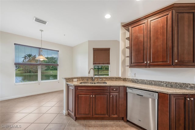 kitchen featuring pendant lighting, sink, dishwasher, light stone counters, and light tile patterned flooring