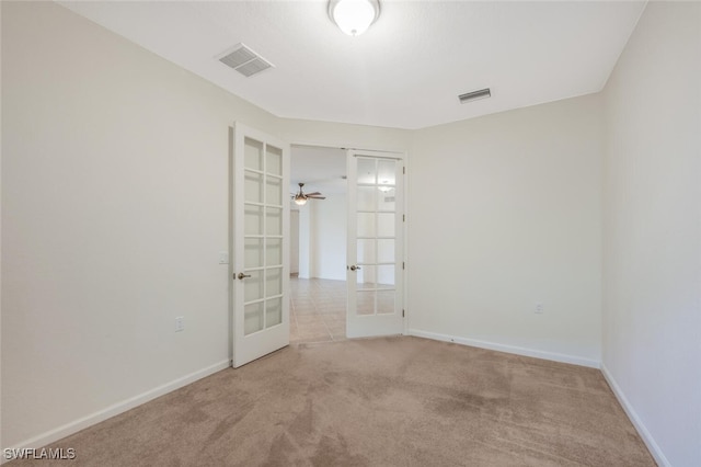 carpeted spare room with french doors