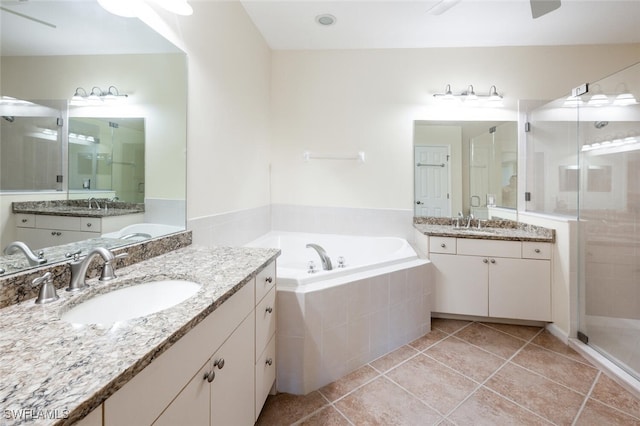 bathroom with tile patterned floors, independent shower and bath, and vanity