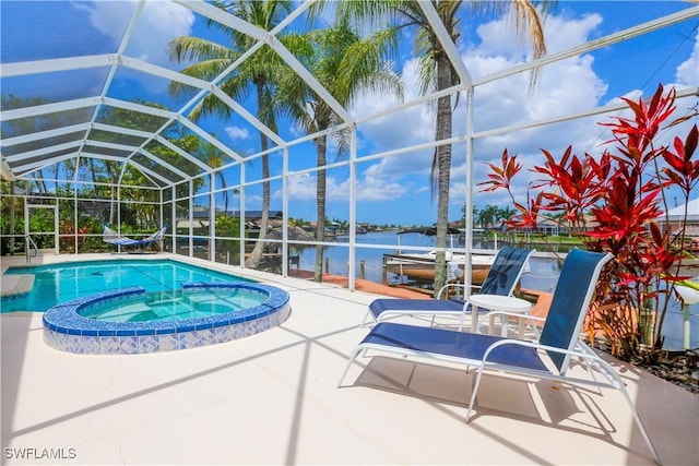 view of pool featuring an in ground hot tub, a lanai, a water view, and a patio