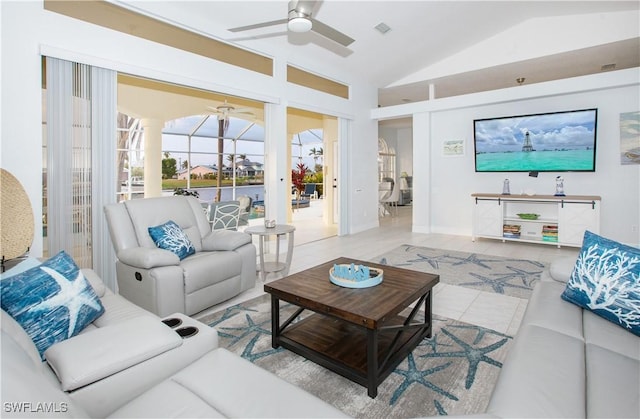 tiled living room featuring ceiling fan and vaulted ceiling