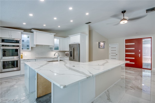 kitchen featuring a large island with sink, white cabinetry, sink, and appliances with stainless steel finishes