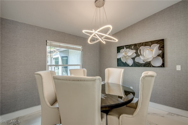 dining space with vaulted ceiling and an inviting chandelier