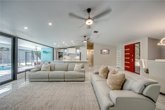 living room with ceiling fan and expansive windows