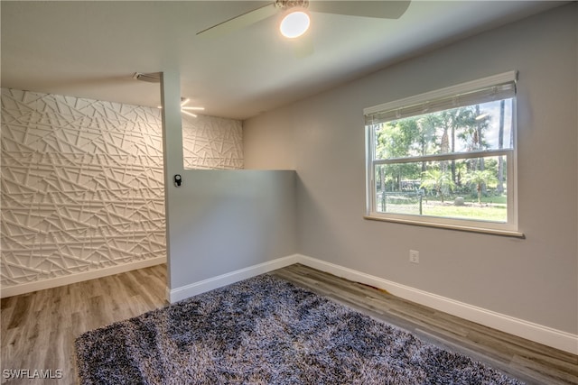 empty room featuring ceiling fan and hardwood / wood-style flooring