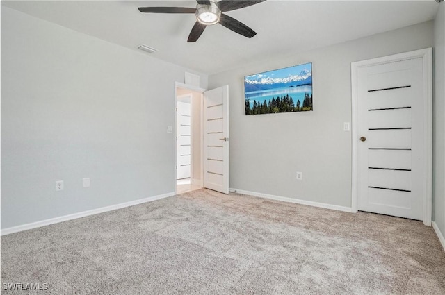 unfurnished bedroom with ceiling fan and carpet