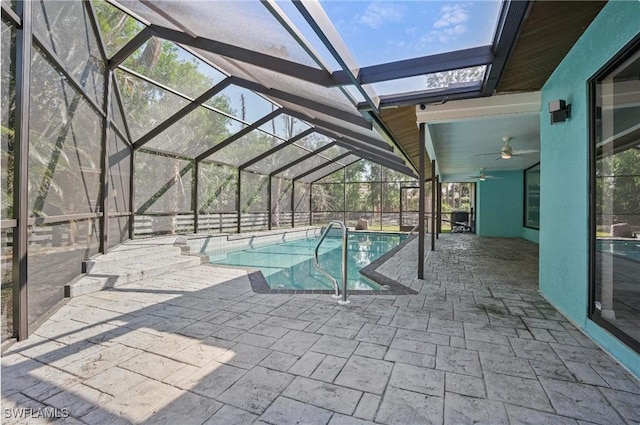 view of pool featuring a patio, ceiling fan, and glass enclosure