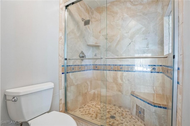 bathroom with an enclosed shower and toilet