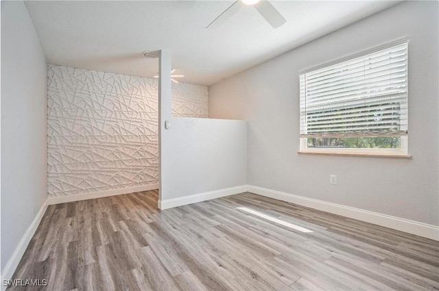 empty room featuring light hardwood / wood-style flooring and ceiling fan