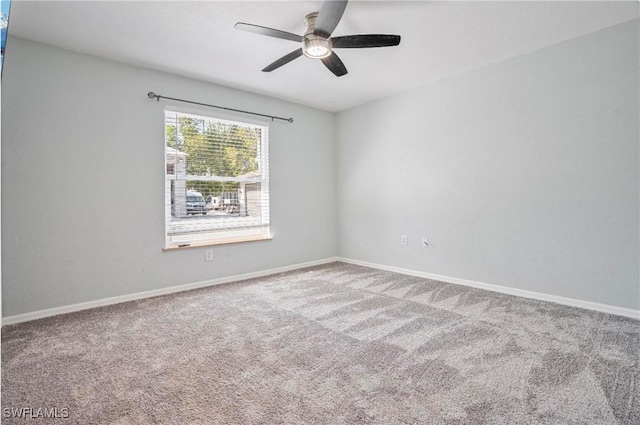 carpeted spare room featuring ceiling fan