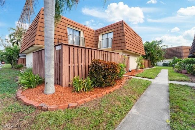 view of side of home featuring a yard