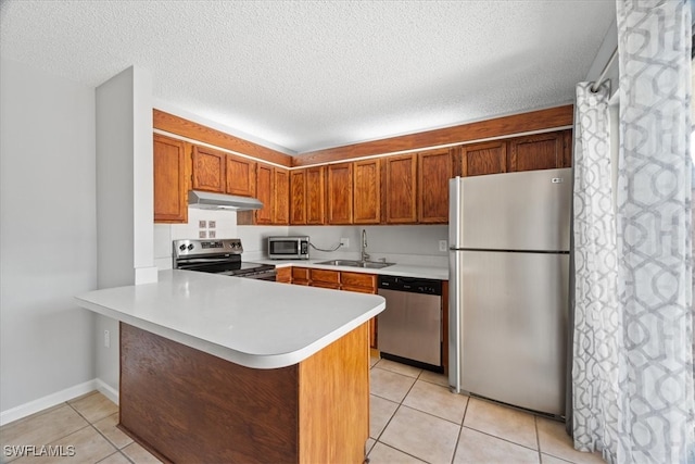 kitchen with kitchen peninsula, sink, light tile patterned flooring, and appliances with stainless steel finishes