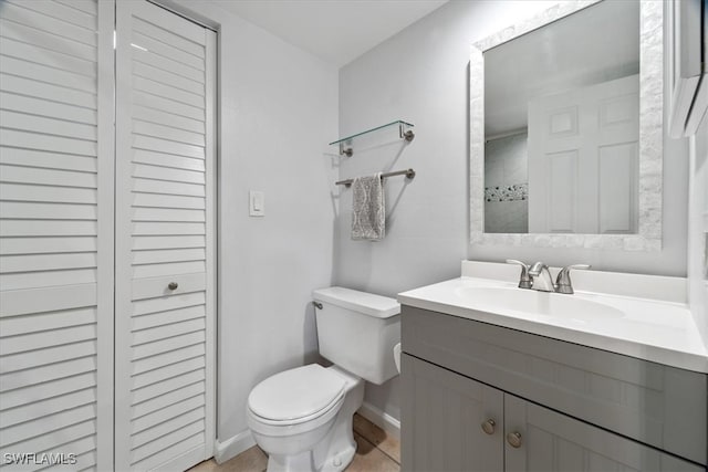 bathroom featuring tile patterned floors, vanity, and toilet