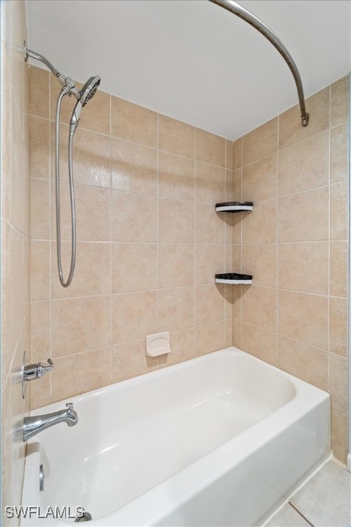 bathroom with tile patterned flooring and tiled shower / bath