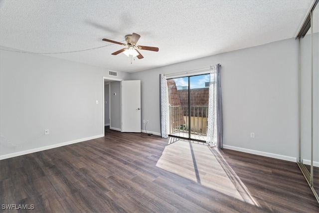 empty room featuring a textured ceiling, ceiling fan, and dark hardwood / wood-style floors