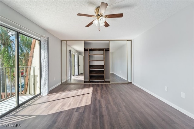 unfurnished bedroom with dark hardwood / wood-style floors, ceiling fan, a textured ceiling, and a closet