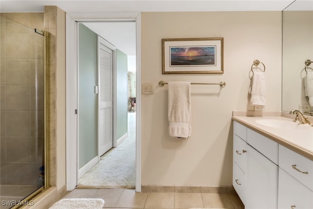 bathroom featuring vanity, tile patterned floors, and a shower with door