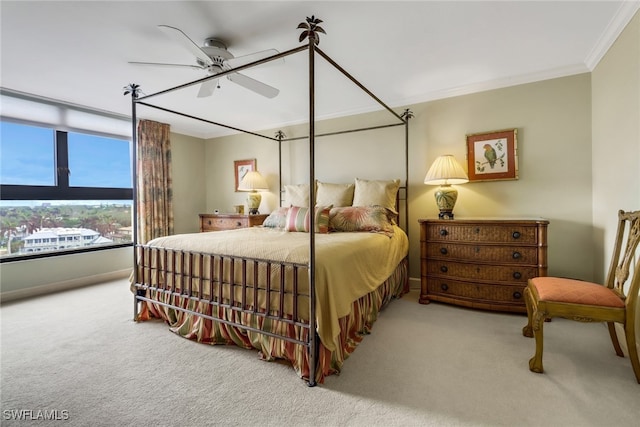 bedroom with carpet flooring, ceiling fan, and crown molding