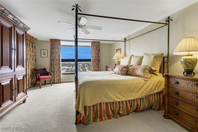 bedroom with ceiling fan, light colored carpet, and ornamental molding