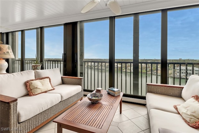 sunroom / solarium featuring ceiling fan, a water view, and a wealth of natural light