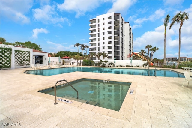 view of pool featuring a patio area and a hot tub