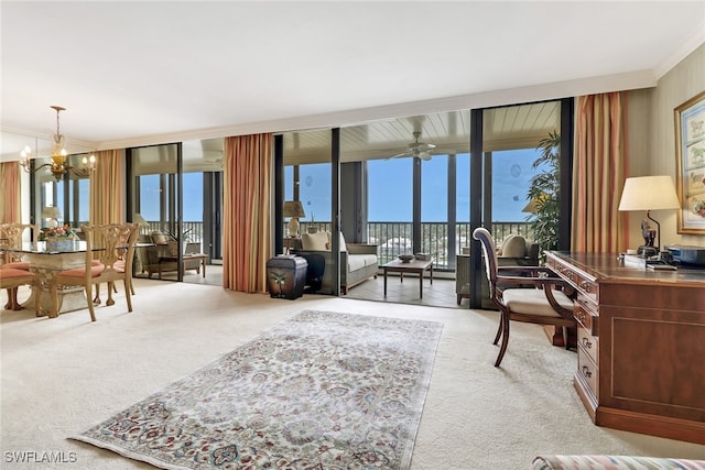 carpeted office with a notable chandelier, expansive windows, and ornamental molding