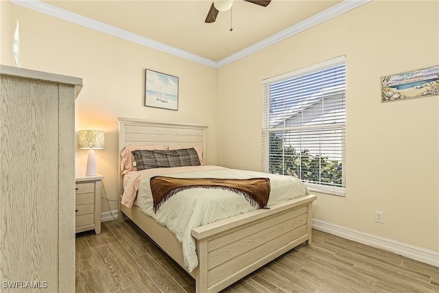 bedroom featuring ceiling fan, light wood-type flooring, and ornamental molding