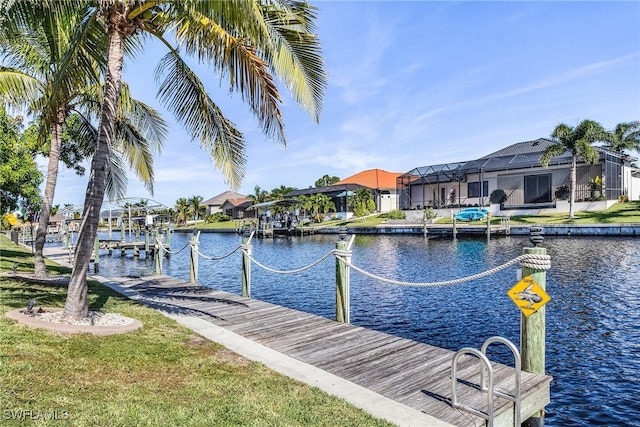 dock area with a yard and a water view