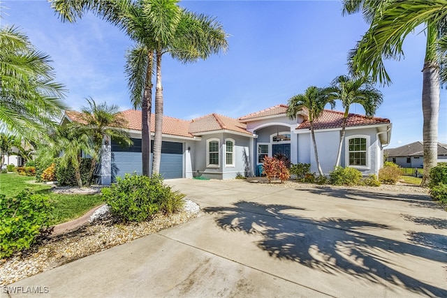 mediterranean / spanish home with a garage