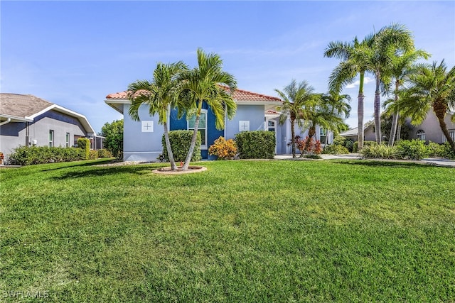 mediterranean / spanish house featuring a front yard