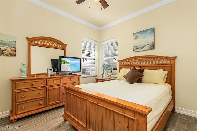 bedroom featuring hardwood / wood-style floors, ceiling fan, and crown molding