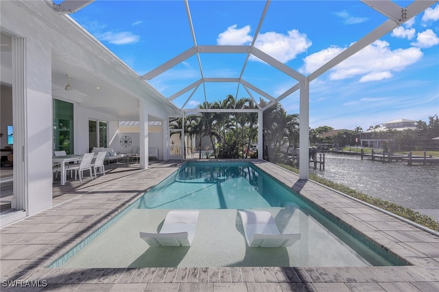 view of pool with a lanai, a patio area, and ceiling fan