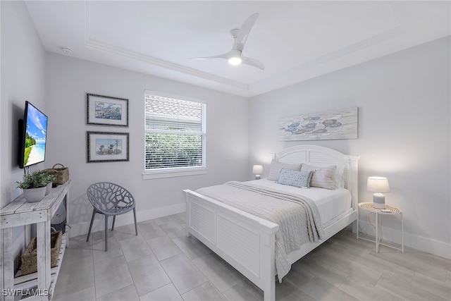 bedroom featuring a tray ceiling and ceiling fan