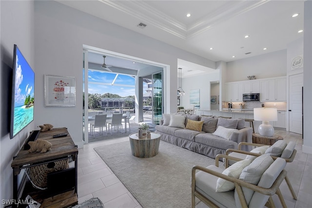 living room featuring crown molding, light tile patterned floors, and ceiling fan