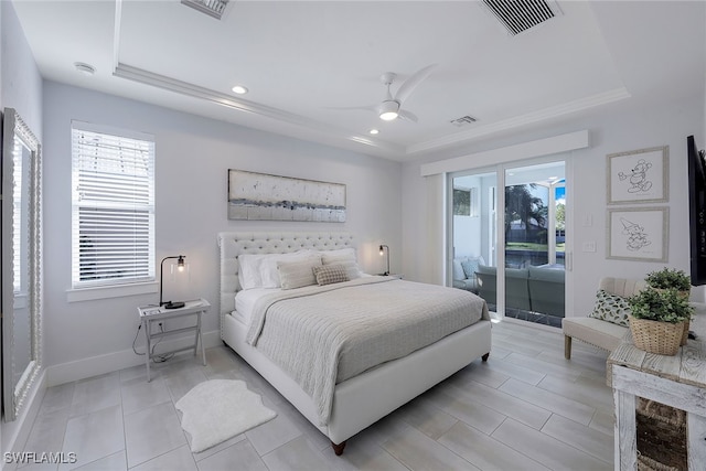 bedroom with access to outside, a raised ceiling, and ceiling fan