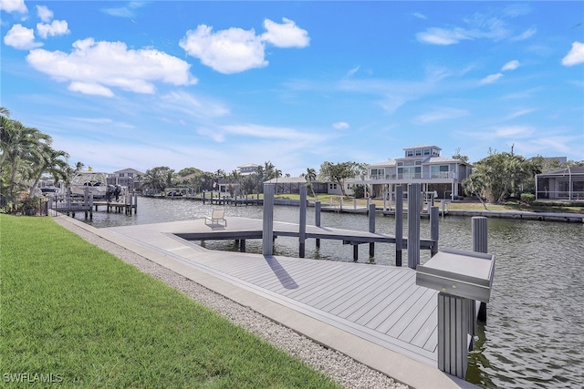 dock area with a yard and a water view