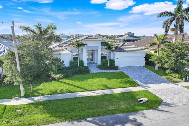 view of front of property with a garage and a front yard