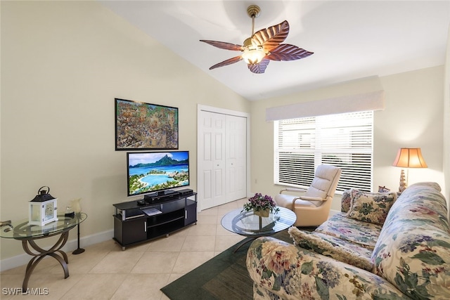 living room with ceiling fan, light tile patterned flooring, and lofted ceiling